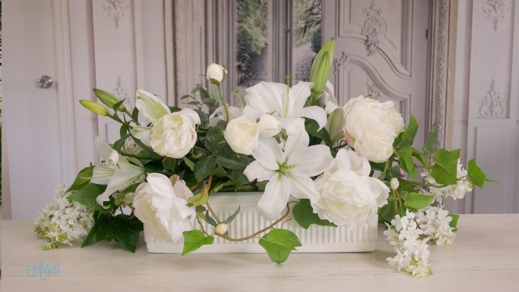 Wedding table flowers of white lilac, peonies and roses