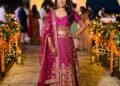 Woman in a magenta and gold lehenga with a sheer dupatta, dressed as a guest at an Indian wedding sangeet