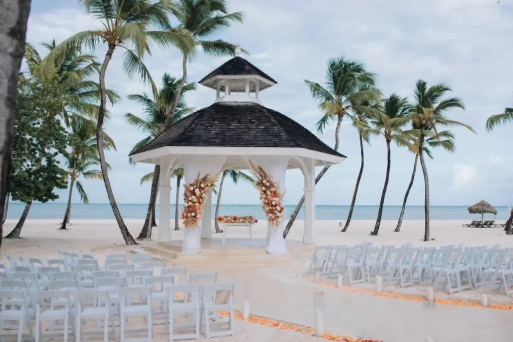 White beach gazebo set for a wedding ceremony at Hyatt Ziva Cap Cana in Punta Cana, with rows of white chairs and floral arrangements facing the Caribbean