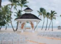 White beach gazebo set for a wedding ceremony at Hyatt Ziva Cap Cana in Punta Cana, with rows of white chairs and floral arrangements facing the Caribbean