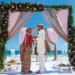 Couple under a floral mandap on the beach at Grand Palladium Costa Mujeres