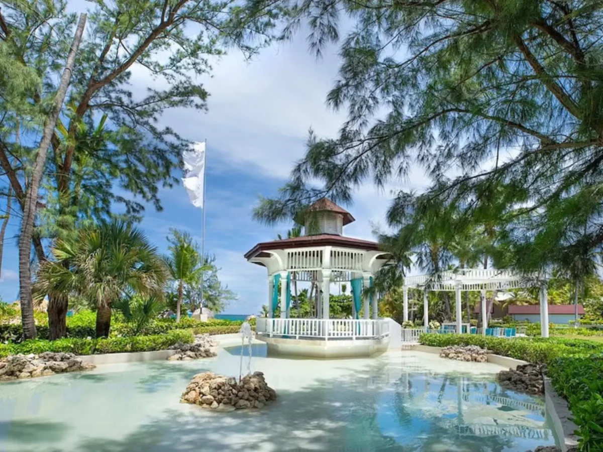 White wedding gazebo surrounded by water and tropical gardens at Grand Palladium Punta Cana Resort and Spa