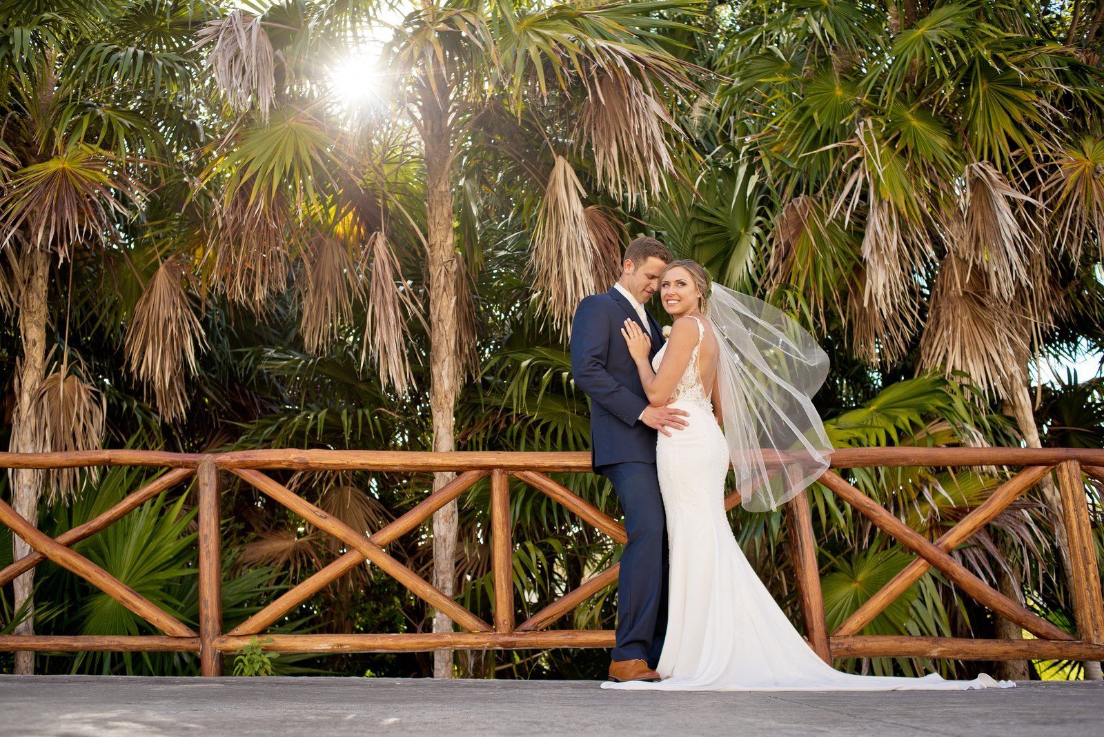 Real couple embracing on their wedding day at The Grand at Moon Palace Resort Cancun
