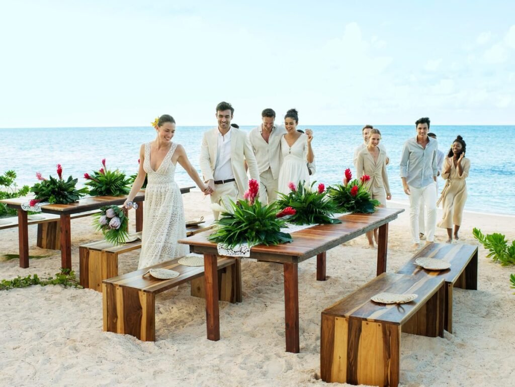 Beachfront wedding table setting with tropical greenery at Excellence Oyster Bay in Jamaica
