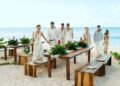 Beachfront wedding table setting with tropical greenery at Excellence Oyster Bay in Jamaica