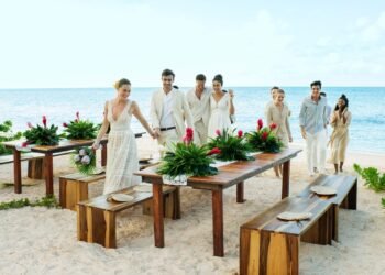 Beachfront wedding table setting with tropical greenery at Excellence Oyster Bay in Jamaica
