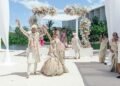 Mandap under a white pergola dressed in pink and white flowers at Grand Palladium Costa Mujeres