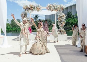 Mandap under a white pergola dressed in pink and white flowers at Grand Palladium Costa Mujeres