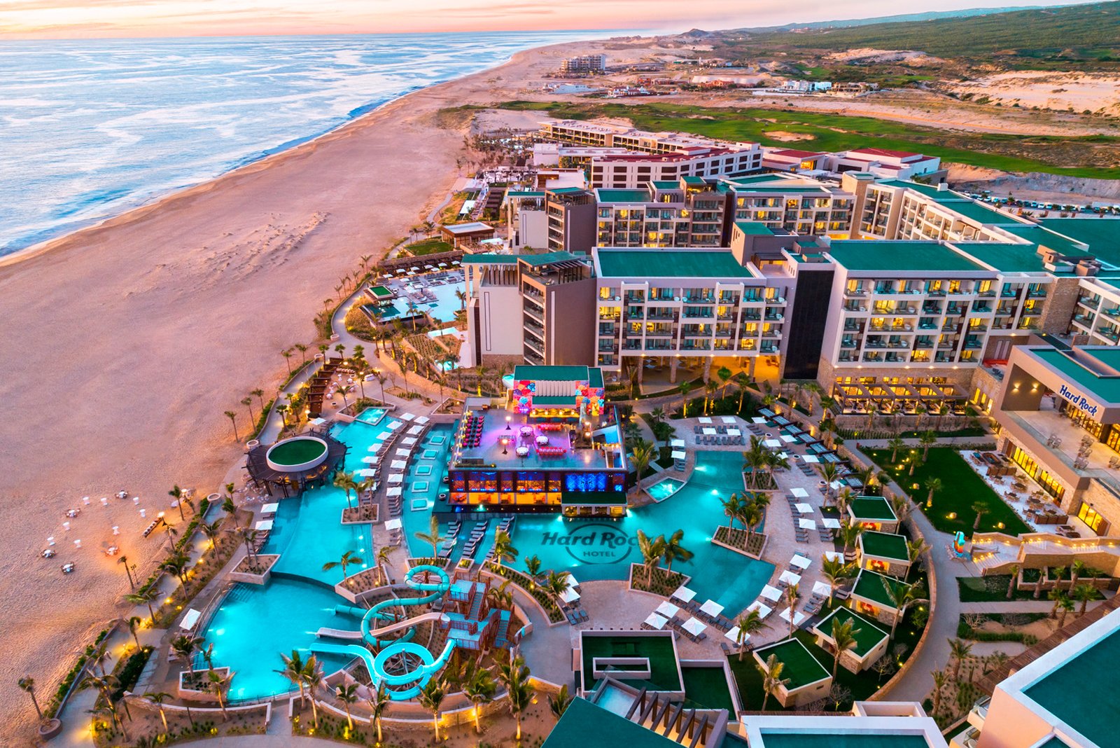 Aerial view of Hard Rock Hotel Los Cabos along the beach at sunset