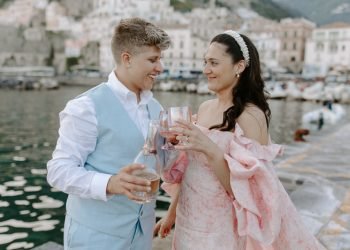 newlyweds cheersing on the beach