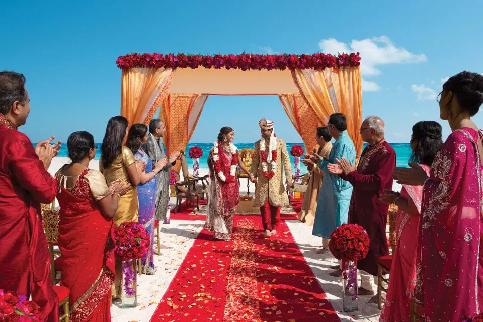 Guests seated for a Hindu wedding ceremony on the beach in Mexico
