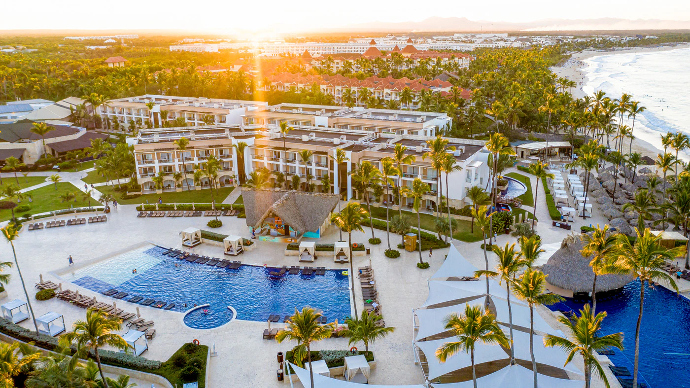 Aerial view of Royalton Punta Cana at sunset showing the resort's rooms, pools and beachfront