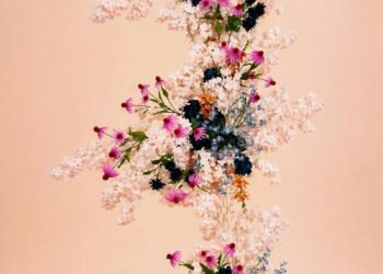 Cascading pink and blue floral wedding arrangement in a pastel garden setting