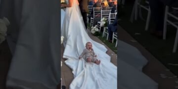 Baby takes a ride on the bride's dress! 🤣 Best wedding moment! 👰‍♀️ #funnykids #wedding #shorts